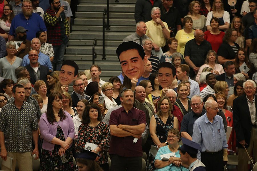 Family and friends bring big-heads to graduation to celebrate.