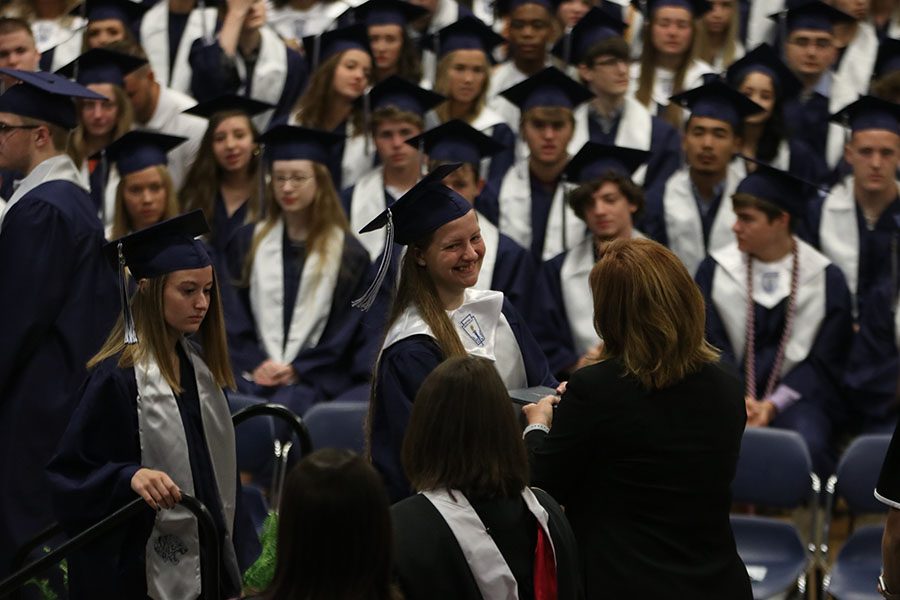 Graduate Jordyn Allen smiles as she receives her diploma.