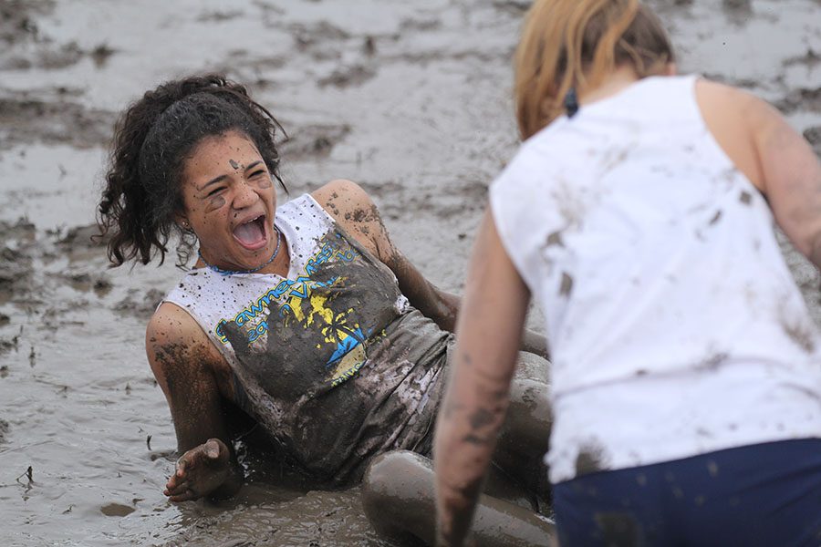 Looking up at a teammate, freshman Sydnie Short recovers from falling into the pool of mud.