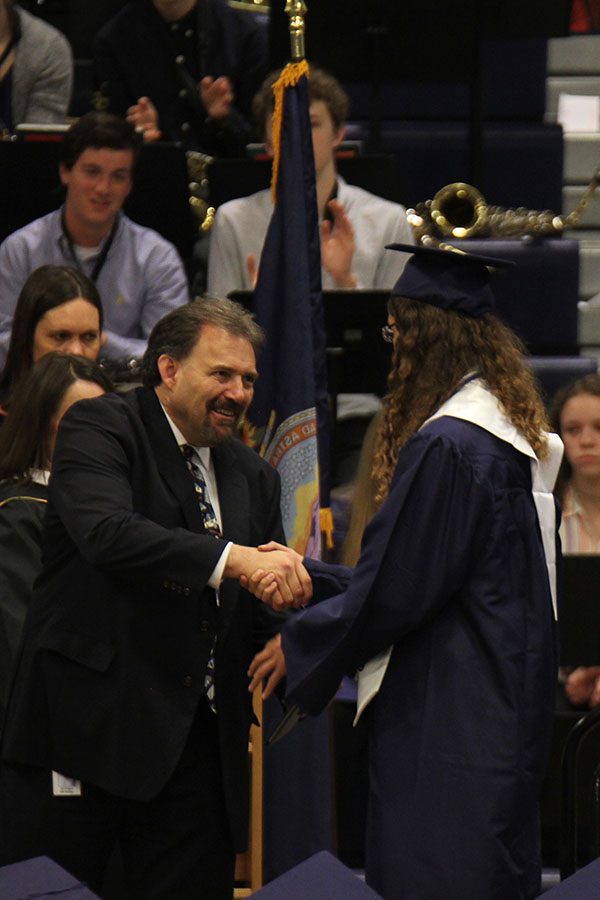 Shaking each seniors hands as the walk across the stage, Board of Administration member John Gaignet, tears up. 