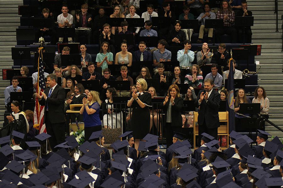 Standing on stage, the Board of Administration and staff clapped for the seniors one last time. 
