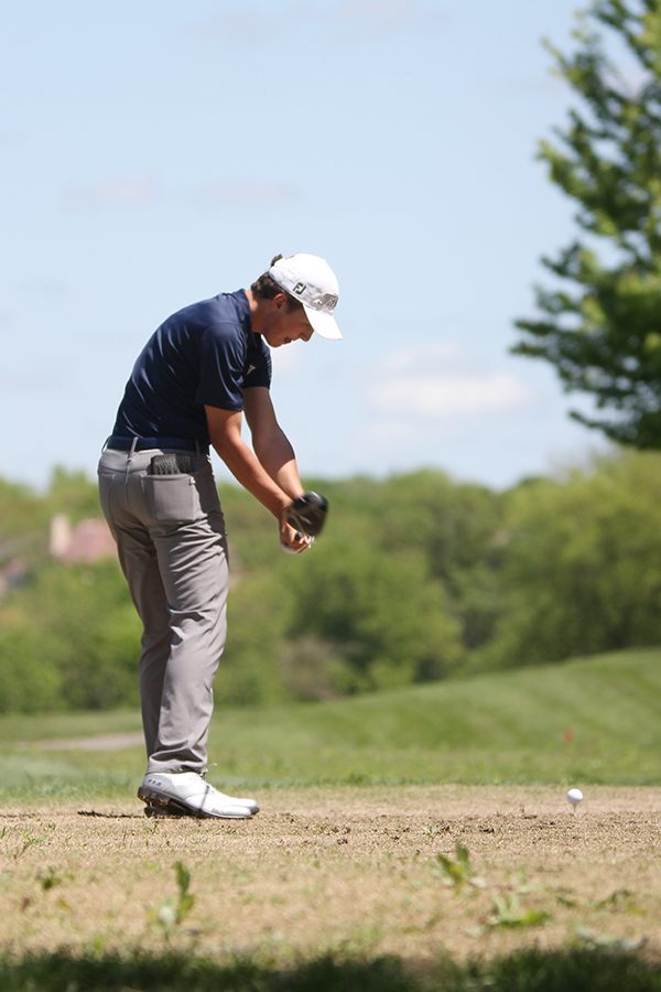 Mid swing, sophomore Nick Mason keeps his eye on the golf ball as he tees off on hole at the Iron Horse Golf Course on May 6th.