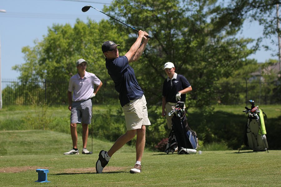 Following through with his swing, senior Nick Davie tees of on hole 9 at the Iron Horse Golf Course on May 6th.