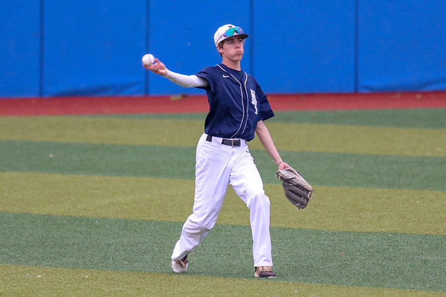 After catching a pop fly, senior Matt Smith throws the ball back to the infield, Friday, May 24. 