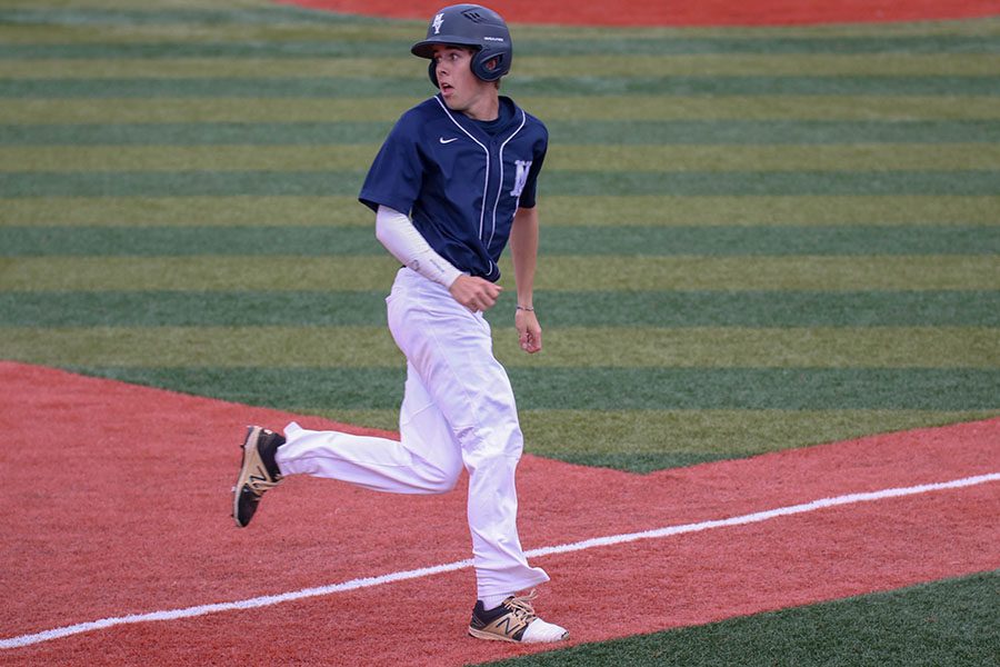 Looking back towards the outfield, senior Matt Smith decides if he should run to home place or stay on third place, Friday, May 24. 