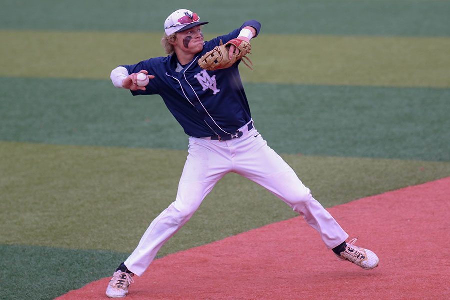 After fielding the ball, senior Cole Moore throws the ball to first base, Friday, May 24.  