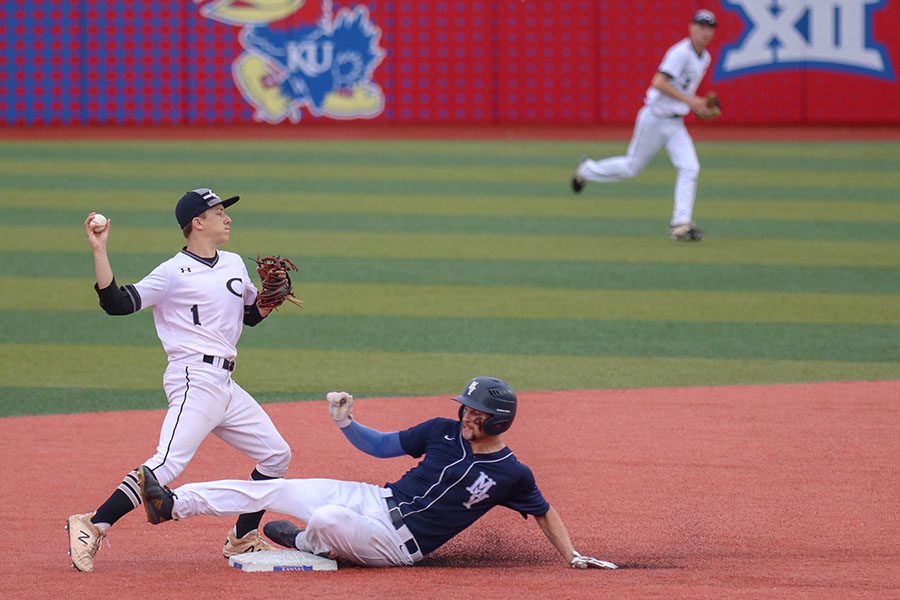 Down on the turf, senior Quinton Hall slides into second base, Friday, May 24. 