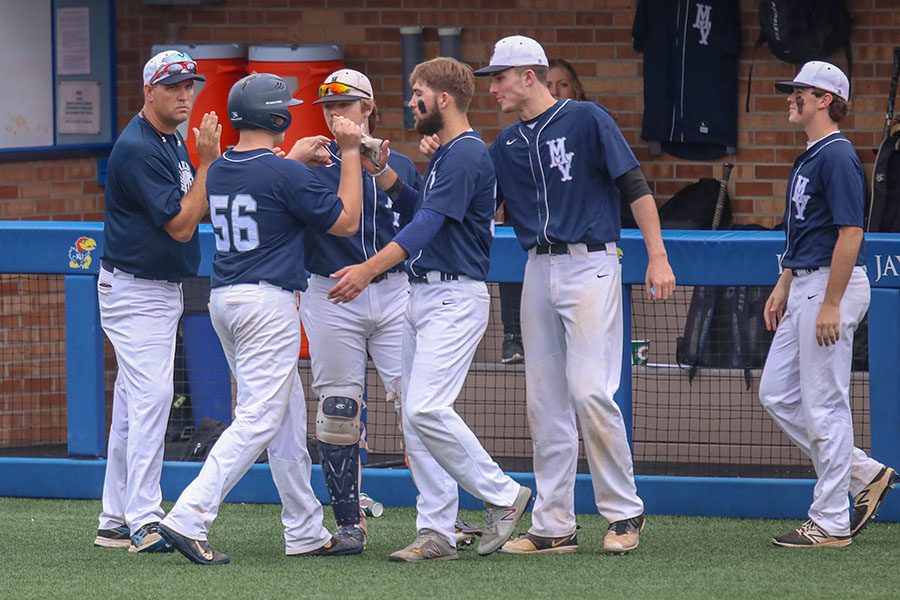 At last year's state baseball tournament, players gather near the dugout to celebrate. This year's baseball season, as well as all other spring sports, are currently set to proceed as normal. However, other local leagues like the Heartland Soccer Association and national leagues like the NCAA, NBA and MLB have cancelled games. 