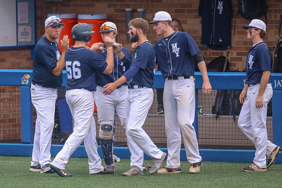 At last years state baseball tournament, players gather near the dugout to celebrate. This years baseball season, as well as all other spring sports, are currently set to proceed as normal. However, other local leagues like the Heartland Soccer Association and national leagues like the NCAA, NBA and MLB have cancelled games. 