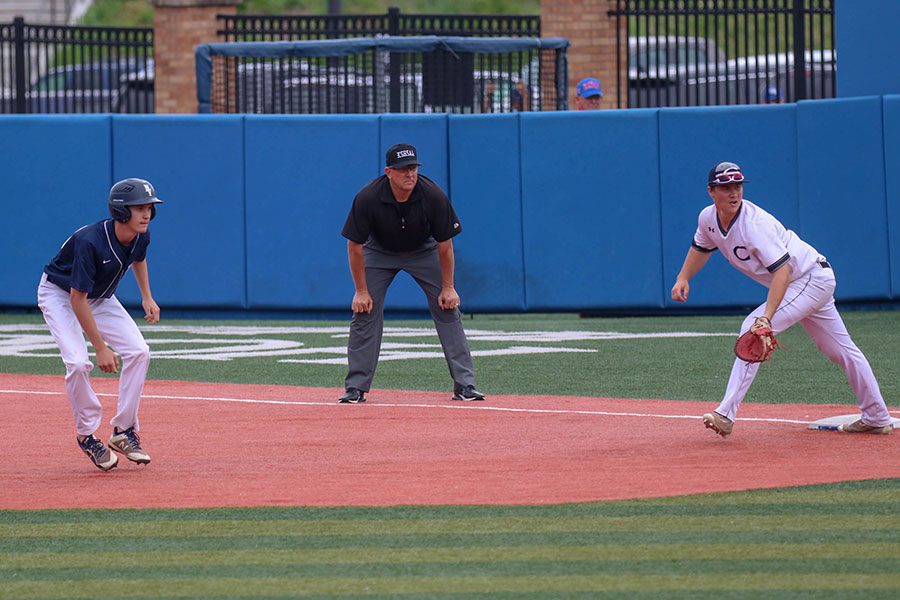 Looking down towards the batter, junior Jake Jones leads off first base, Friday, May 24.