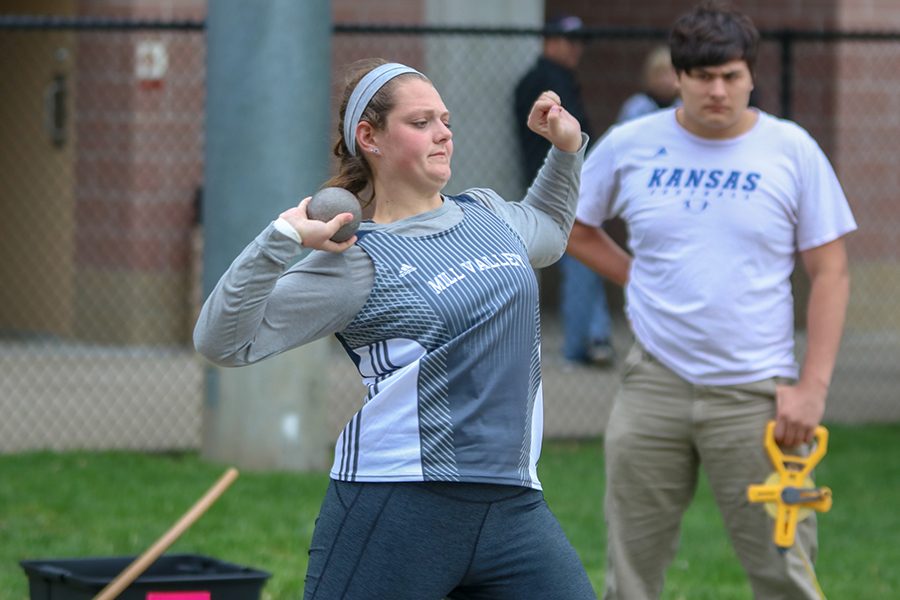 Looking towards the pit, senior Makayla King prepares to throw the shot put. 