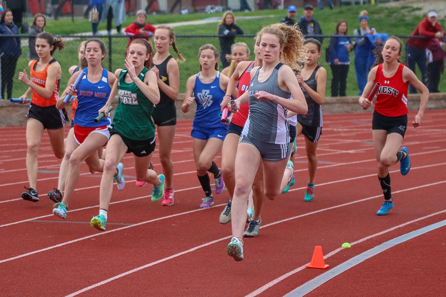 Starting the 4x800 meter relay, sophomore Molly Ricker leads a pack of runners. 