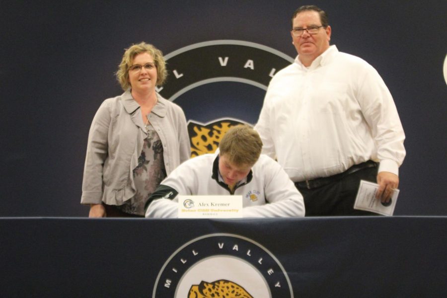 After signing to play baseball at Briar Cliff University, Alex Kremer sits with his parents.