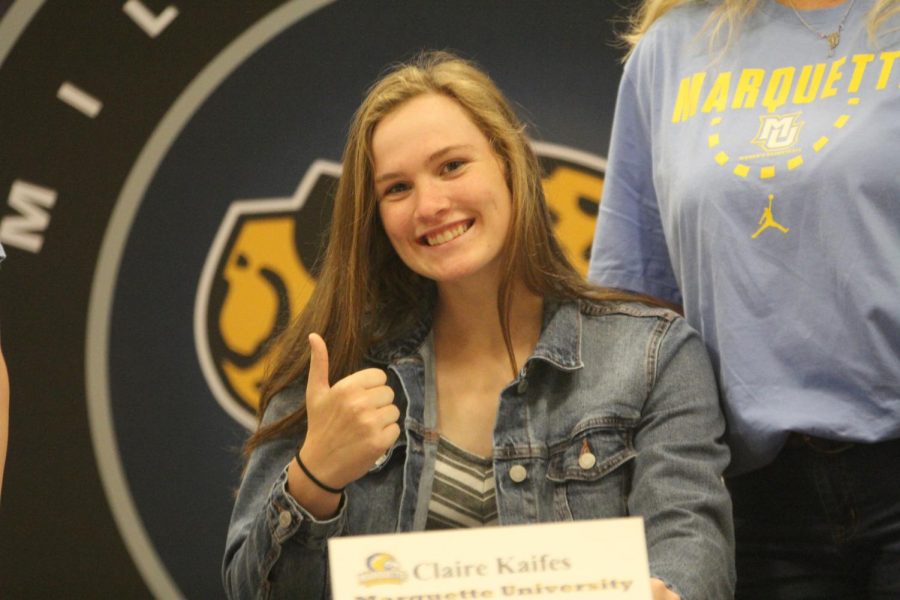 After signing to play basketball at Marquette University, Claire Kaifes smiles with her parents.