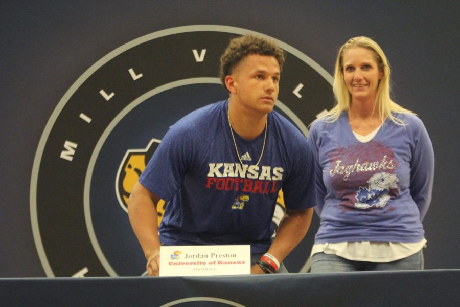 After signing to play football at University of Kansas, Jordan Preston smiles with his mother.
