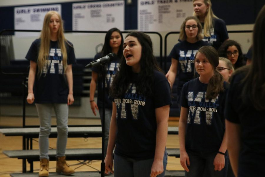 Stepping up to the microphone during the song “Seasons of Love from the musical “Rent,” freshman Kira Tilden sings her solo in the treble choir for the Pop Show Thursday, May 9. 