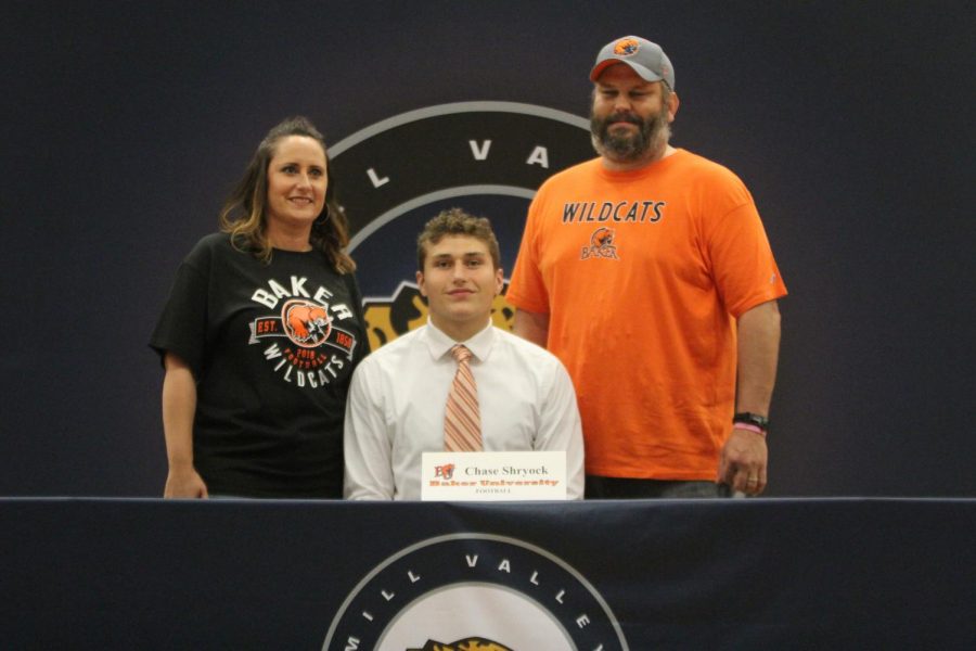 After signing to play football at Baker University, Chase Shyrock smiles with his parents.