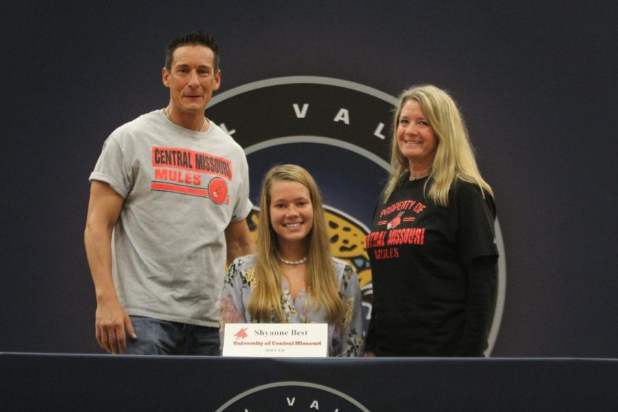 After signing to play soccer at University of Central Missouri, Shyanne Best smiles with her parents.