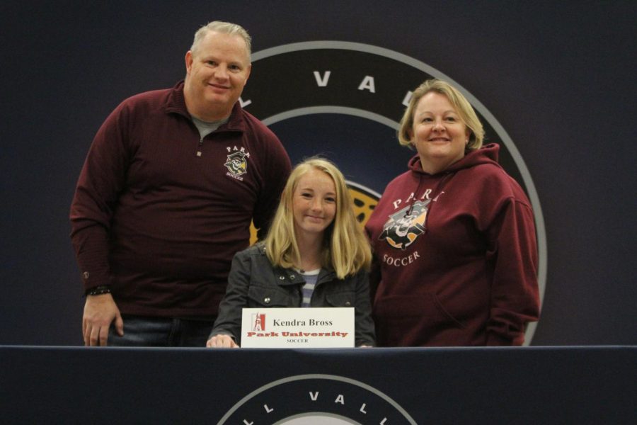 After signing to play soccer at Park University, Kendra Bross smiles with her parents.