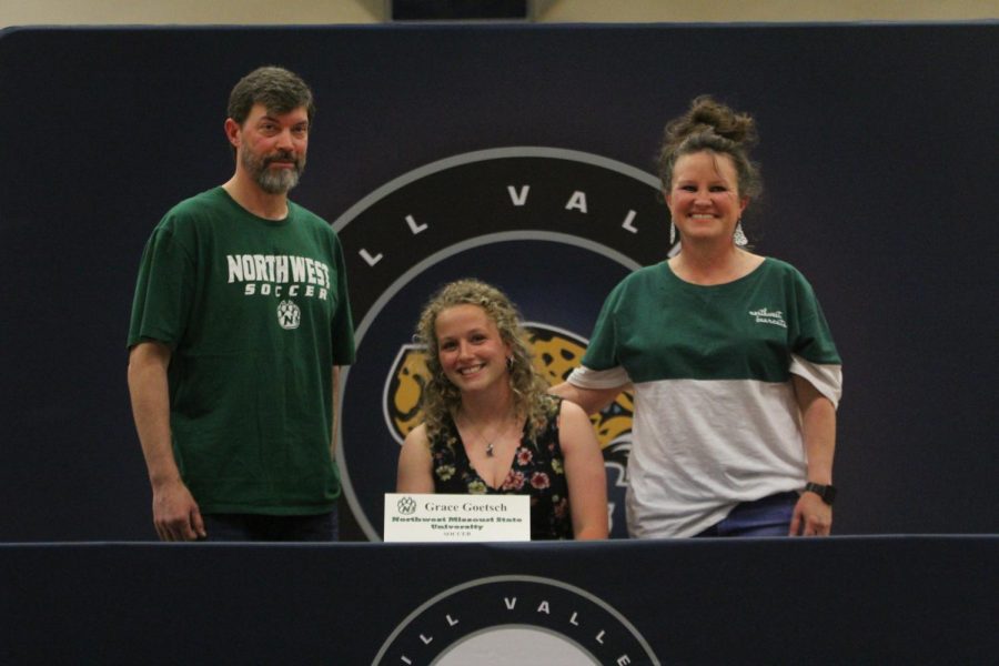 After signing to play soccer at Northwest Missouri State University, Grace Goetsch smiles with her parents.