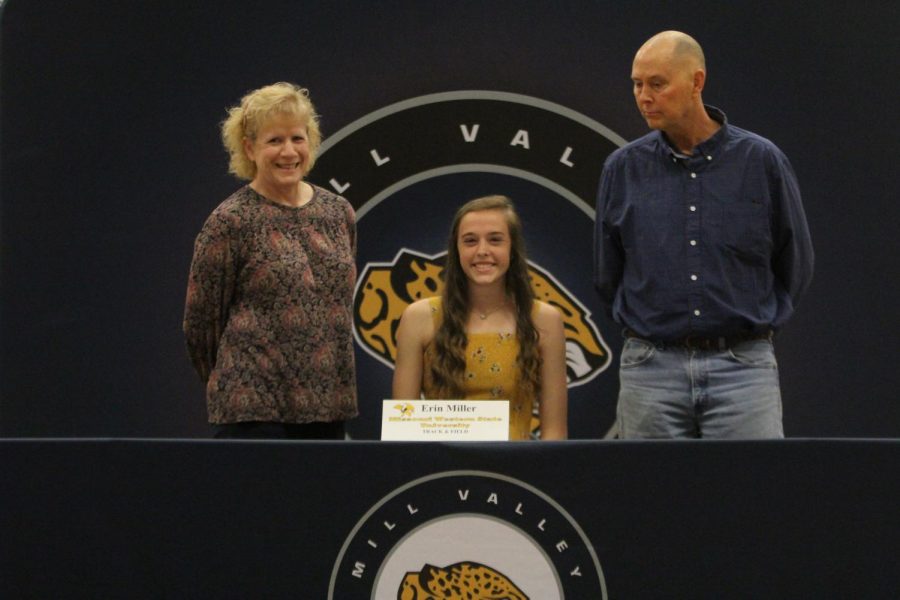 After signing to compete in track and field for Missouri Western State University, Erin Miller smiles with her parents.