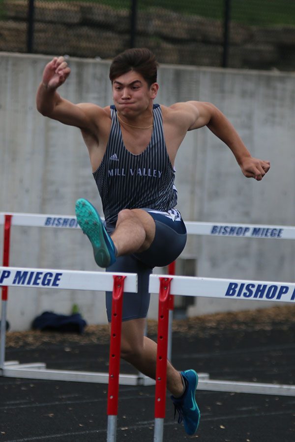 Preparing to jump over a hurdle, senior Eli Midyett competes 110m hurdles.