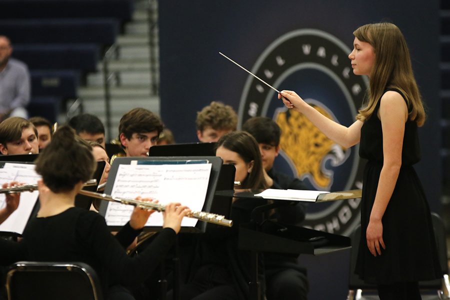 Signaling a decrescendo in the music, senior Megan Dillon directs the band. Dillon composed the piece “Variegated Visions” to showcase her journey through high school.