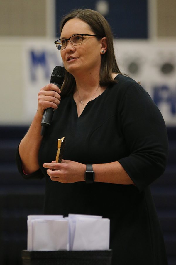 Holding the outstanding senior award, band Director Deb Steiner explains the award would go to the senior with the most points. Points are added every time a member attends a sporting game or steps in when needed.