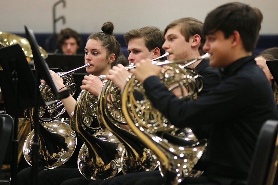 During the last song of the night, junior Rebecca Hurtog joins other members of her section to finish “The Hexagon” by John Fannin.