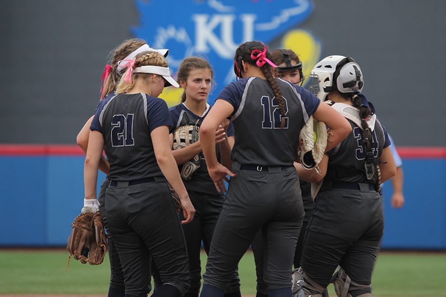 Meeting at the pitchers mount, sophomore Ava Bredwell, juniors Taylir Charest, Paige Oliver, Lauren Florez, Jess Garcia and senior Payton Totzke discuss how to stop the opposing team from scoring. 