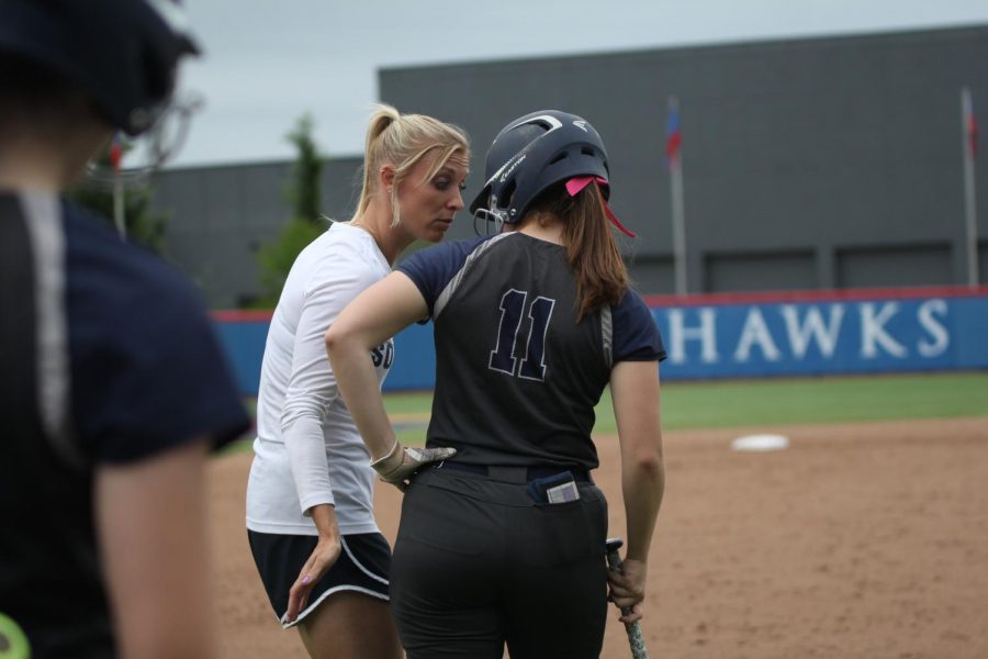 During junior Kylie Conners at bat, head coach Jessica Dewild gives her a pep talk.