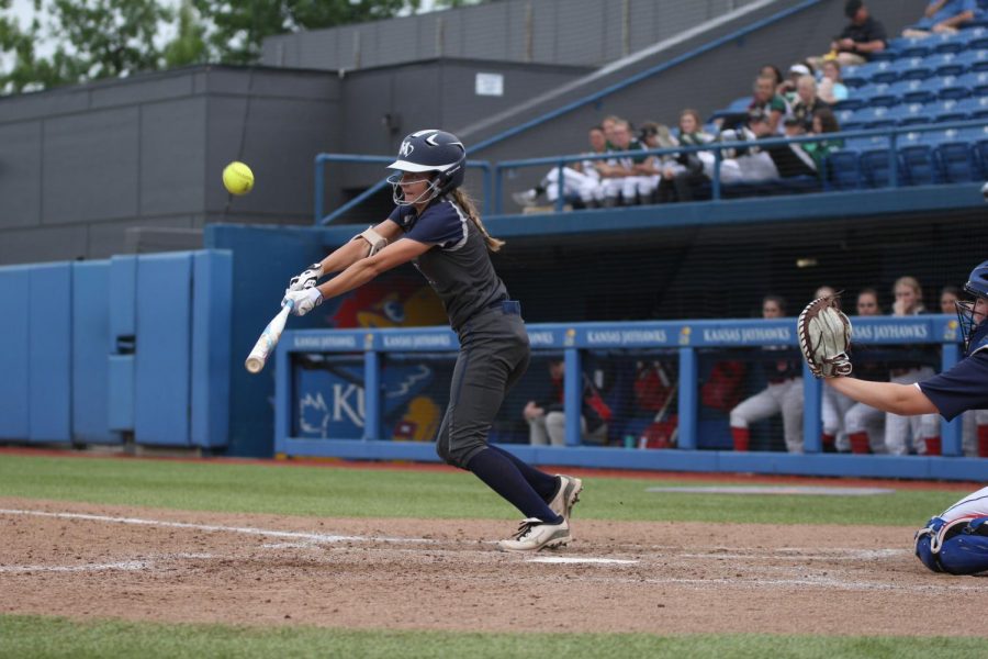 Reaching for the ball, senior Payton Totzke pushes it into the outfield.