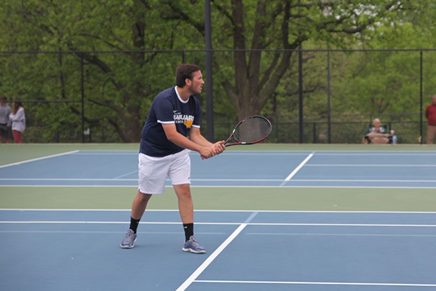 In preparation to return the ball, senior Jacob Hoffman gets into a stance. 
