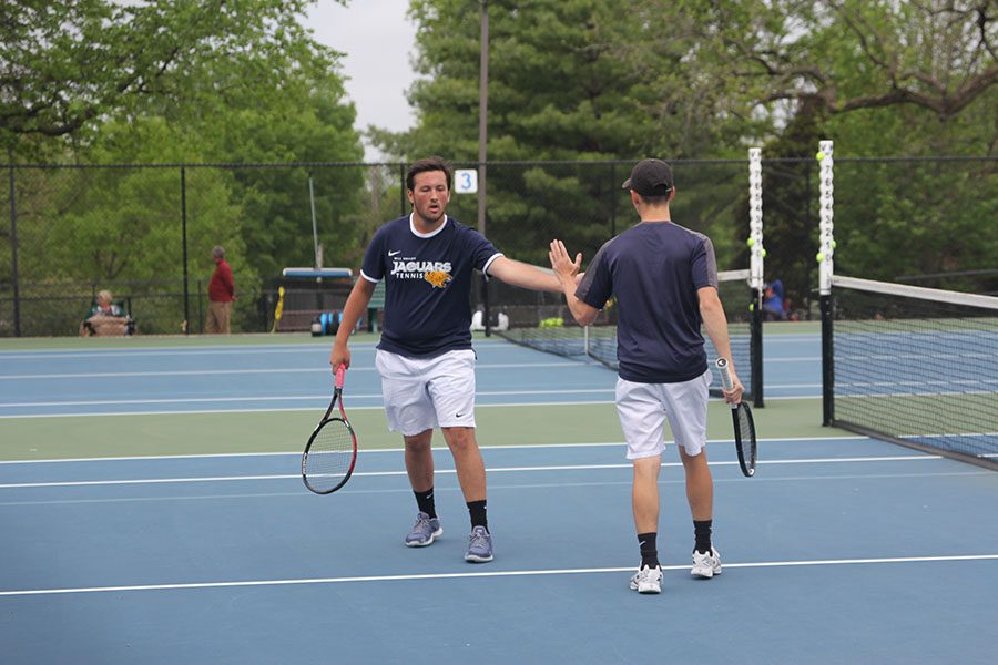 During their doubles match, seniors Eric Schanker and Jacob Hoffman high five.
