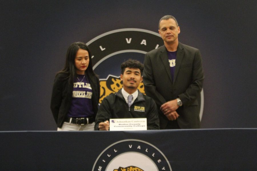 After signing to play baseball at Butler County Community College, Jonathan Contreras smiles with his parents.