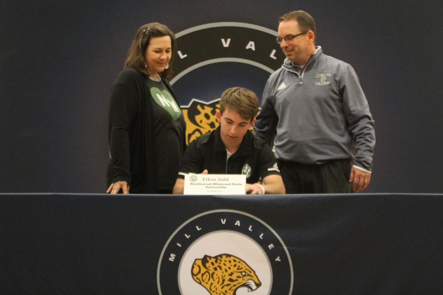 Signing to play baseball at Northwest Missouri State University, Ethan Judd sits with his parents.