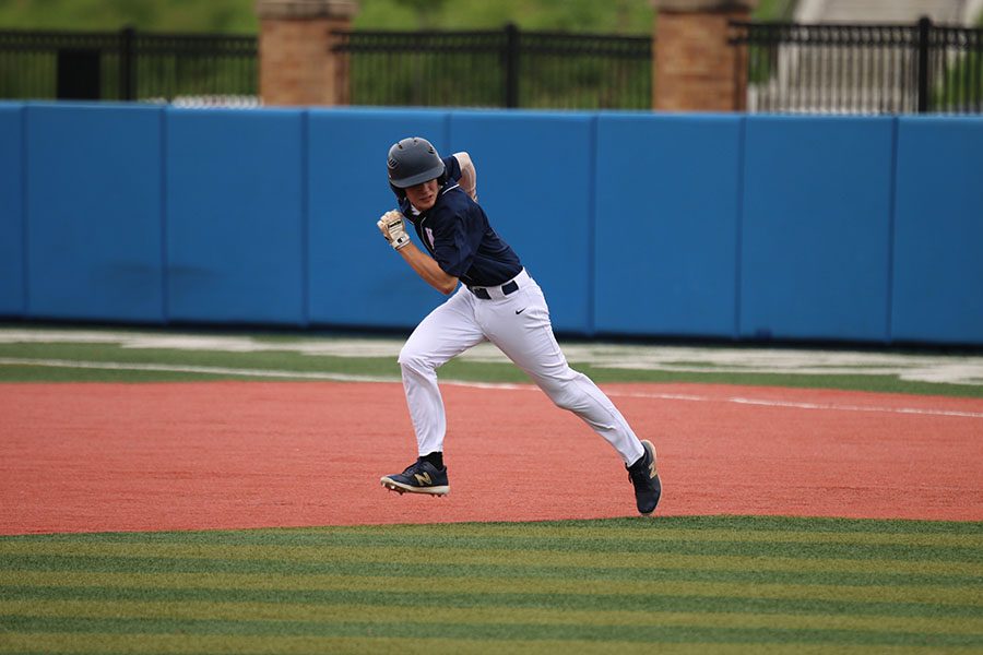 Looking to see where the ball is, sophomore Lucas Pringle sprints to second base, Thursday, May 23.