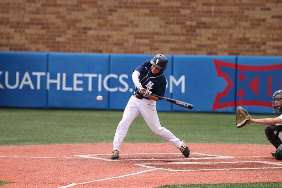 Making contact with the ball, sophomore Sam Leaver hits the ball to center field, Thursday, May 23. 