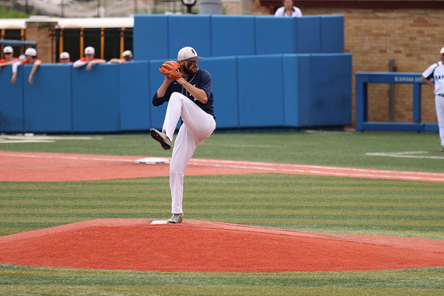 Winding up to pitch, senior Ethan Keopke strikes out the batter, Thursday, May 23.