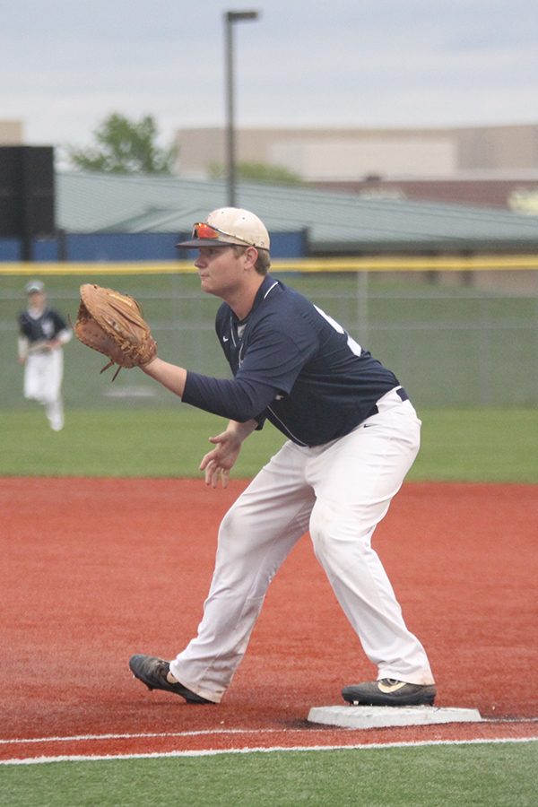 Leaning forward, senior Alex Kremer prepares to make a catch .