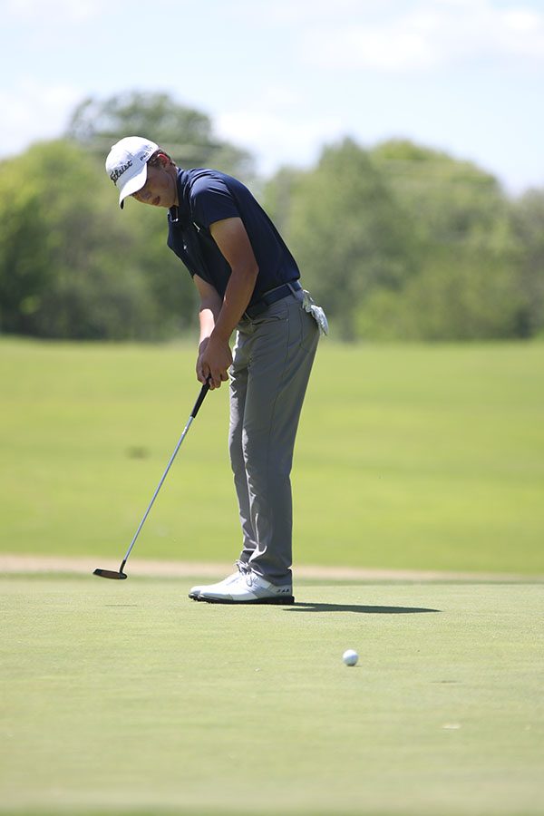 After putting his ball, sophomore Nick Mason watches it get closer to the hole.