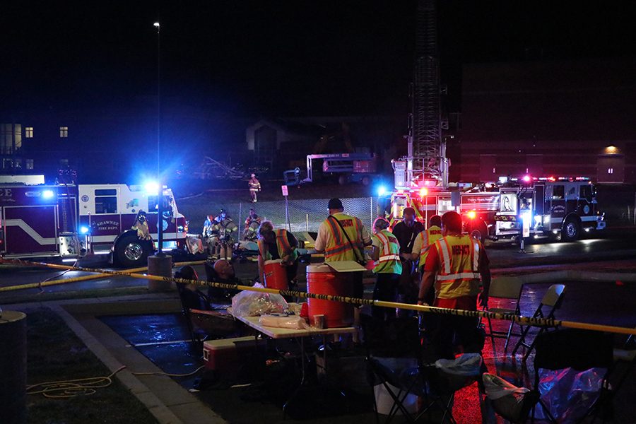 With the fire out, Shawnee firefighters get checked out by paramedics.  