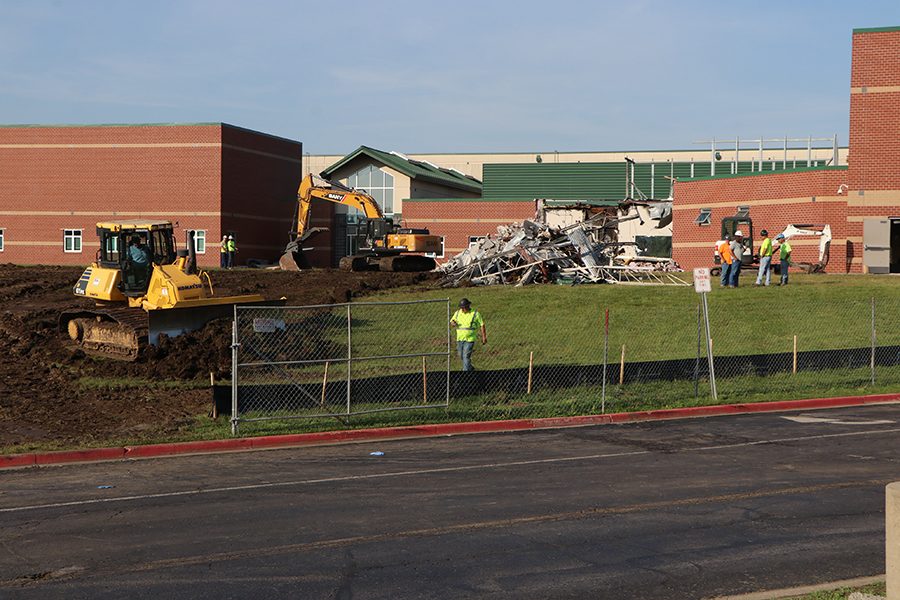 Less than 12 hours after the fire started, construction workers continue to demolish the weight room, Friday, June 7. 