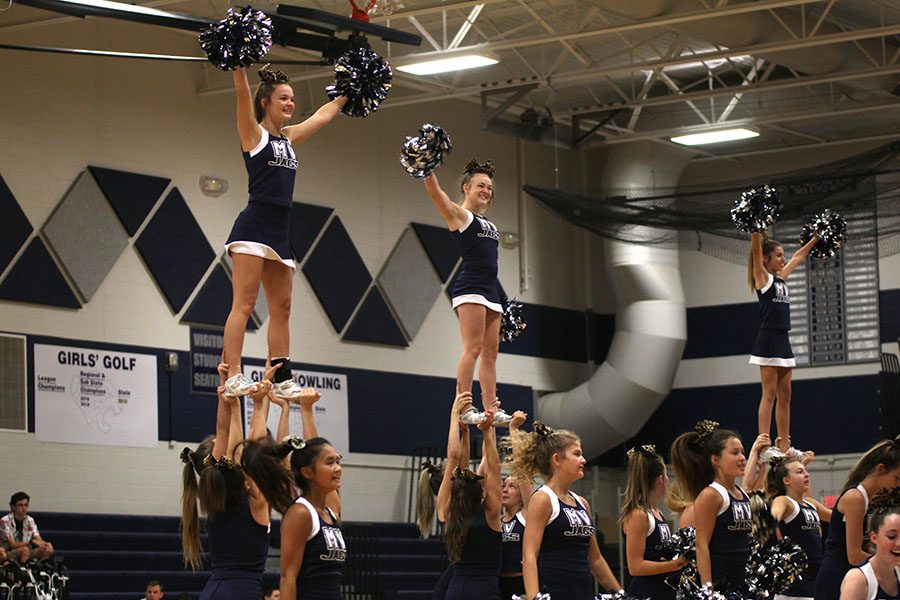 The cheer team performs a routine at the welcoming pep assembly.