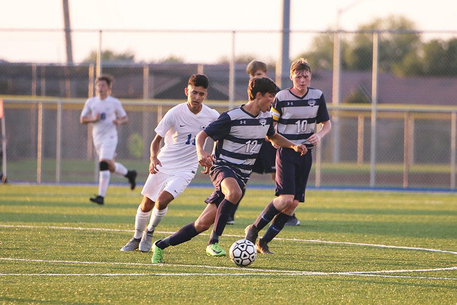 After gaining control of the ball from his opponent, senior Anthony Pentola dribbles the ball in the opposite direction during the game against Gardner on Friday, Aug. 30.