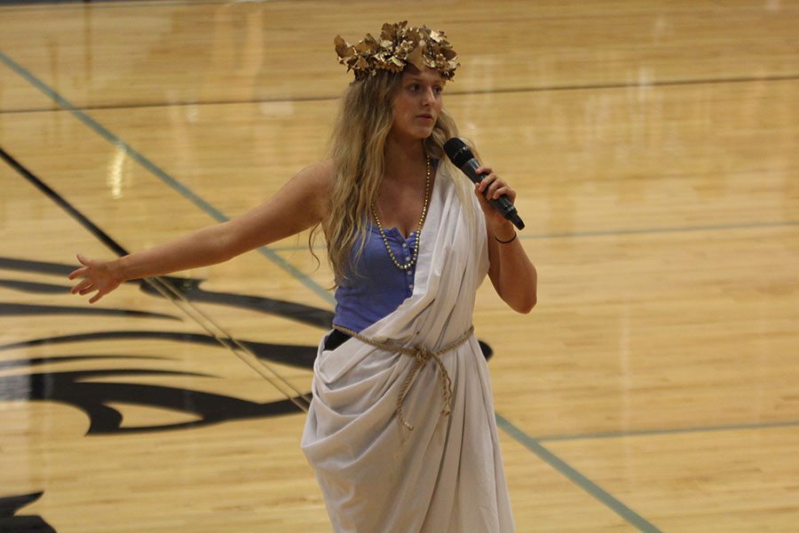 Dressed in a toga, student body president Annie Bogart addresses incoming freshmen during the pep assembly. 