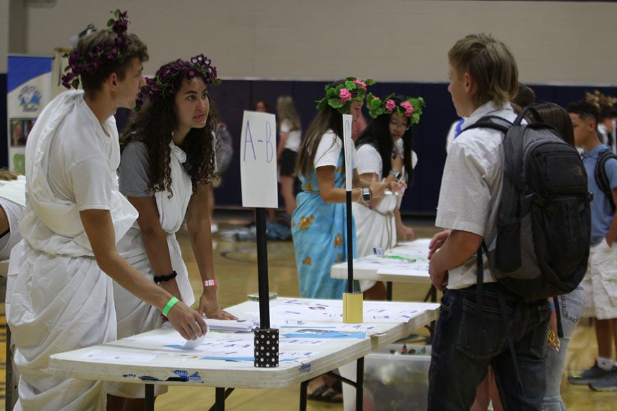 Junior Ben Wieland and junior Nicole Crist help freshman Lane Burson find his schedule.