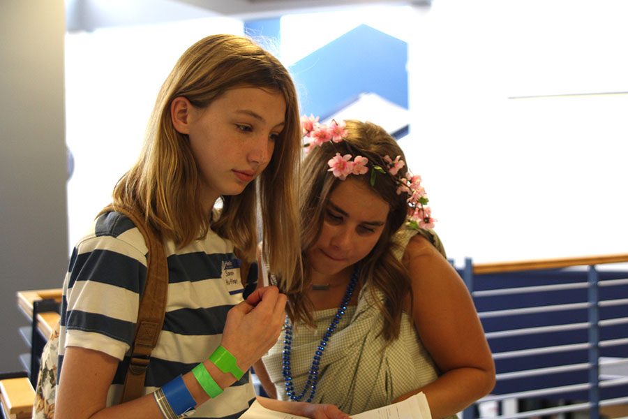Sophomore Elise Canning guides freshman Sarah Huffman to the next class on her schedule. 