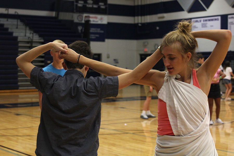 Senior Mallory Scheelk and an incoming freshmen perform a square dancing routine. 
