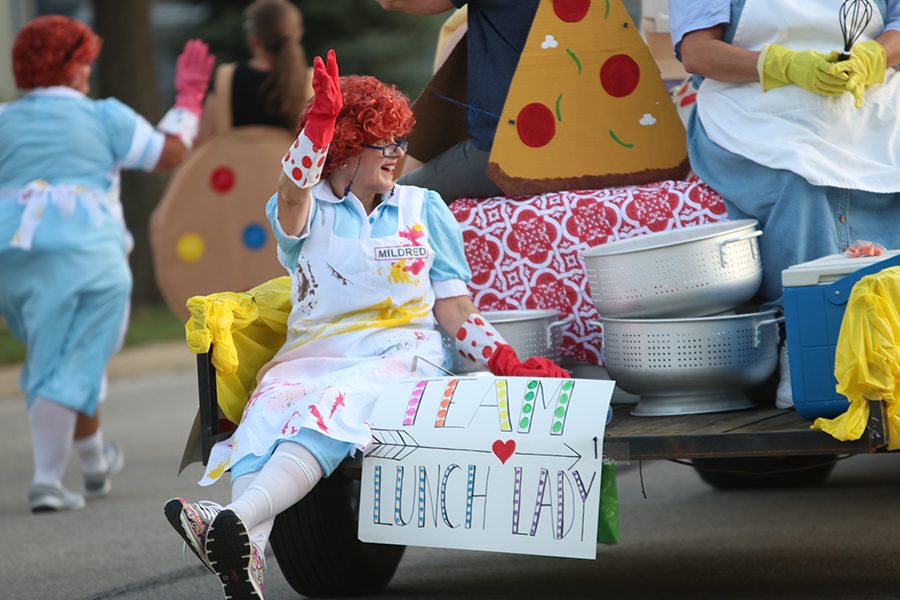 As the parade comes to a close, one of the lunch ladies waves to the public from the back of her float.